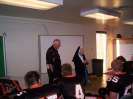 2003 Sr. Audrey praying with Springdale Football team vs. North Catholic